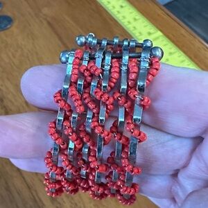 Handmade Red Beaded Silver Bracelet. Seed beads cover silver wires.